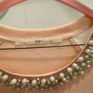 Sweat shirt body with see through mesh sleeves and pearl accents